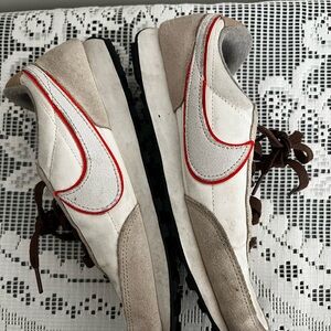 Woman’s Nike White and Brown Sneakers with Orange Accent